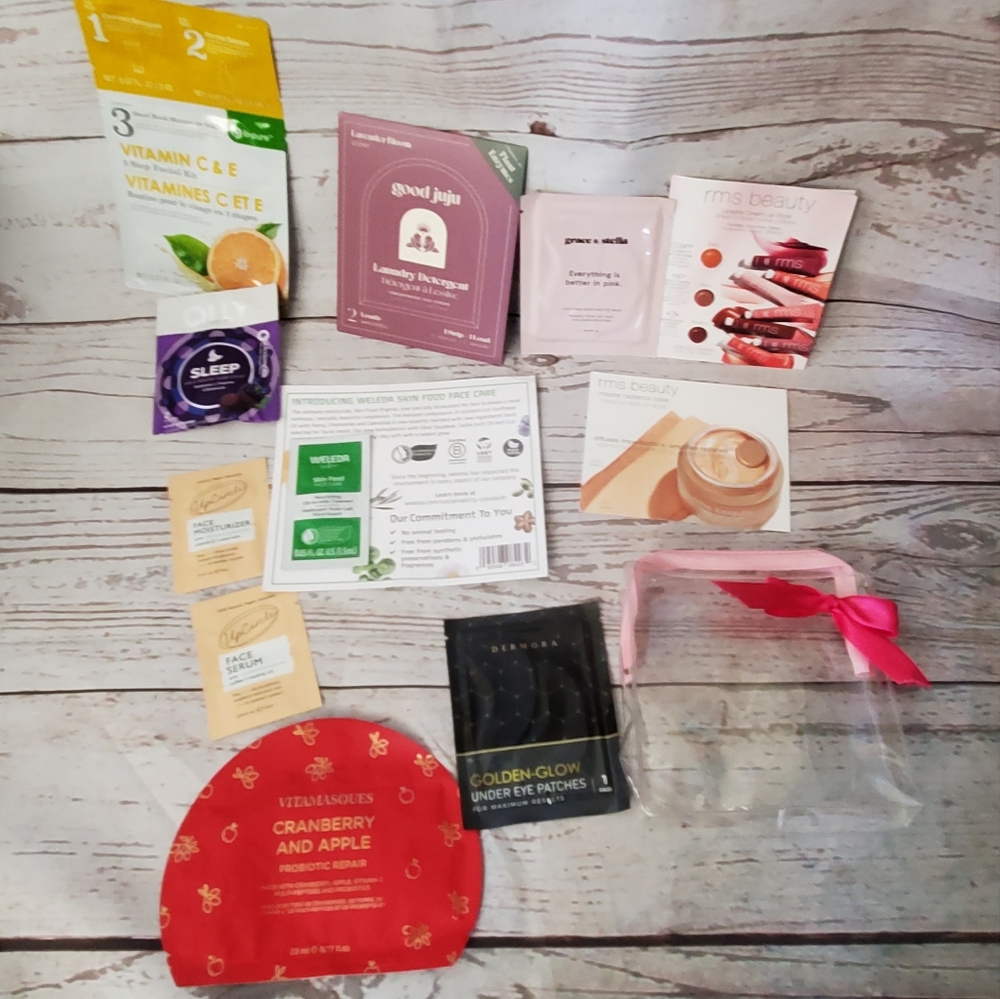 Clear plastic makeup bag with pink bow and assortment of samples